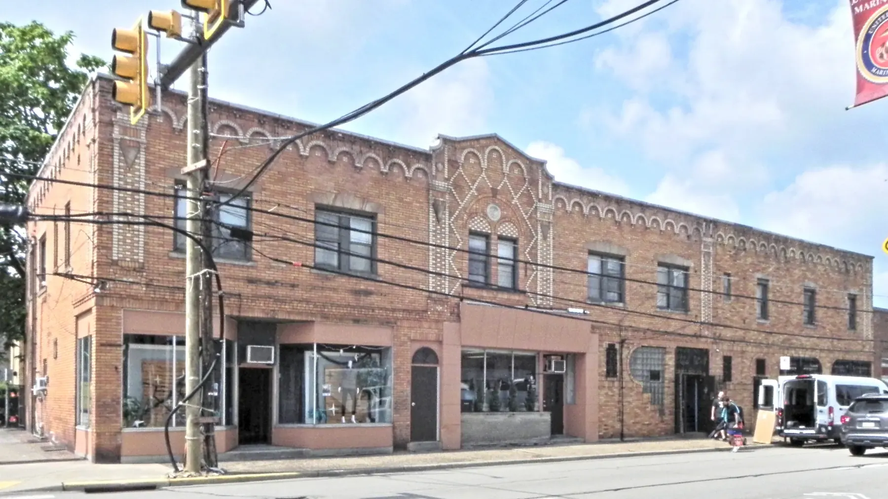 A two-story brick commercial block with storefronts on 4th Avenue in Coraopolis
