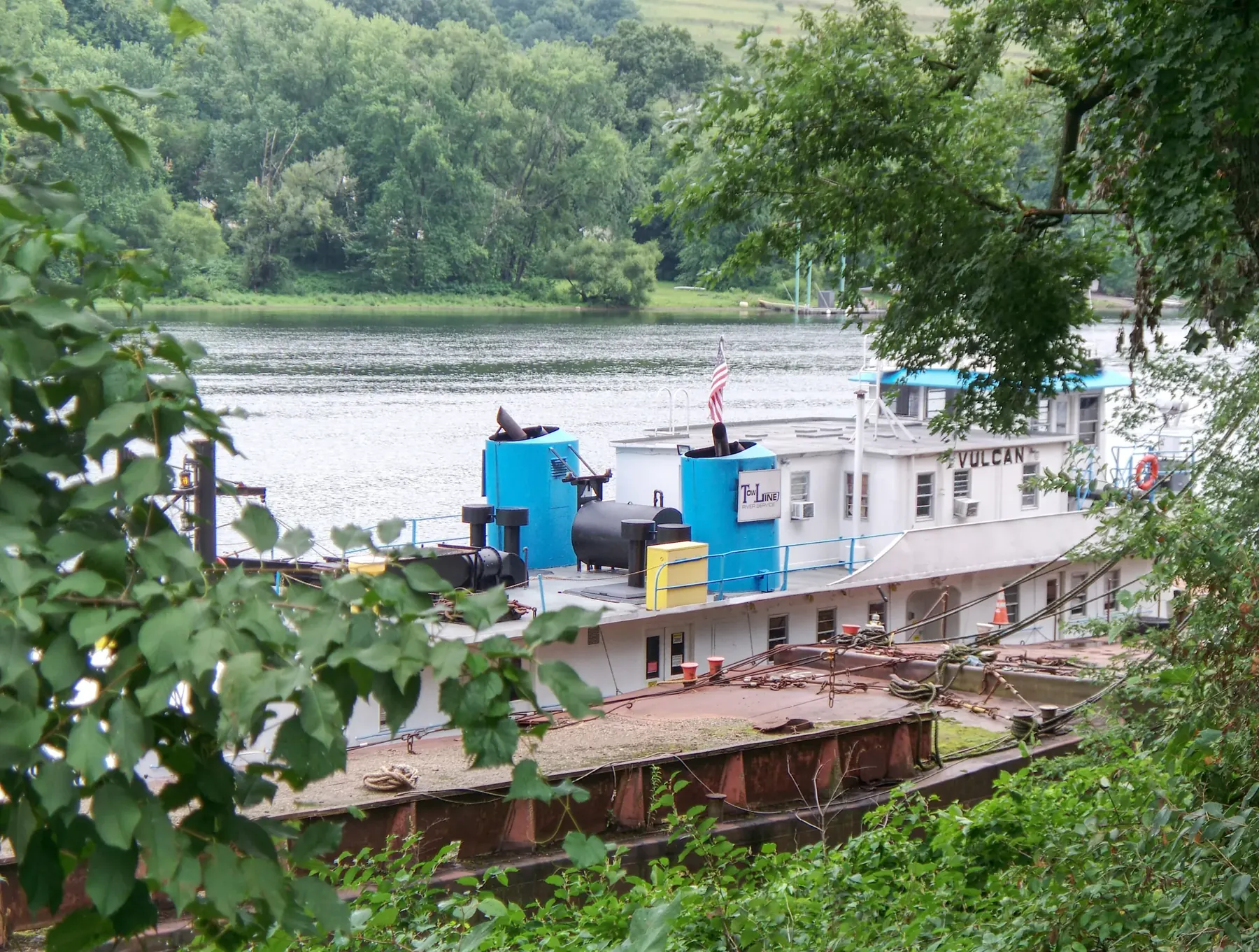 A towboat on the Ohio River at Neville Island, seen through trees
