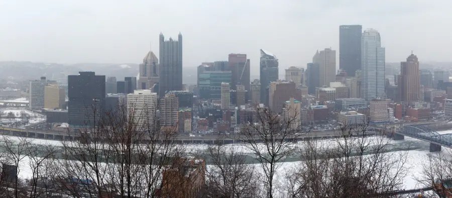 Snow falling on downtown Pittsburgh, with iced rivers and the Smithfield Street Bridge, seen from Mount Washington