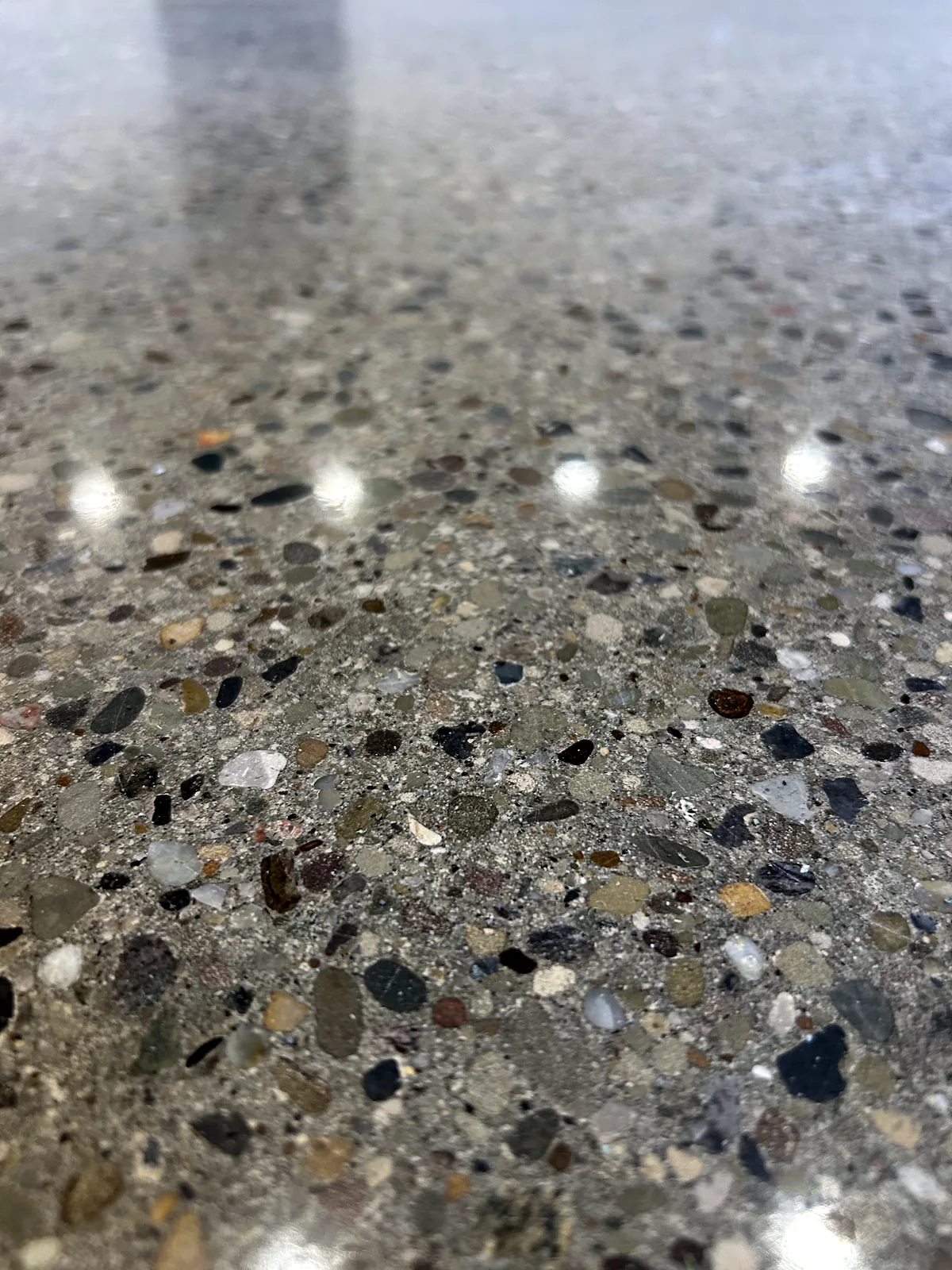 Very close view of a ground and polished concrete floor with exposed stone aggregate and soft background, Pittsburgh area.